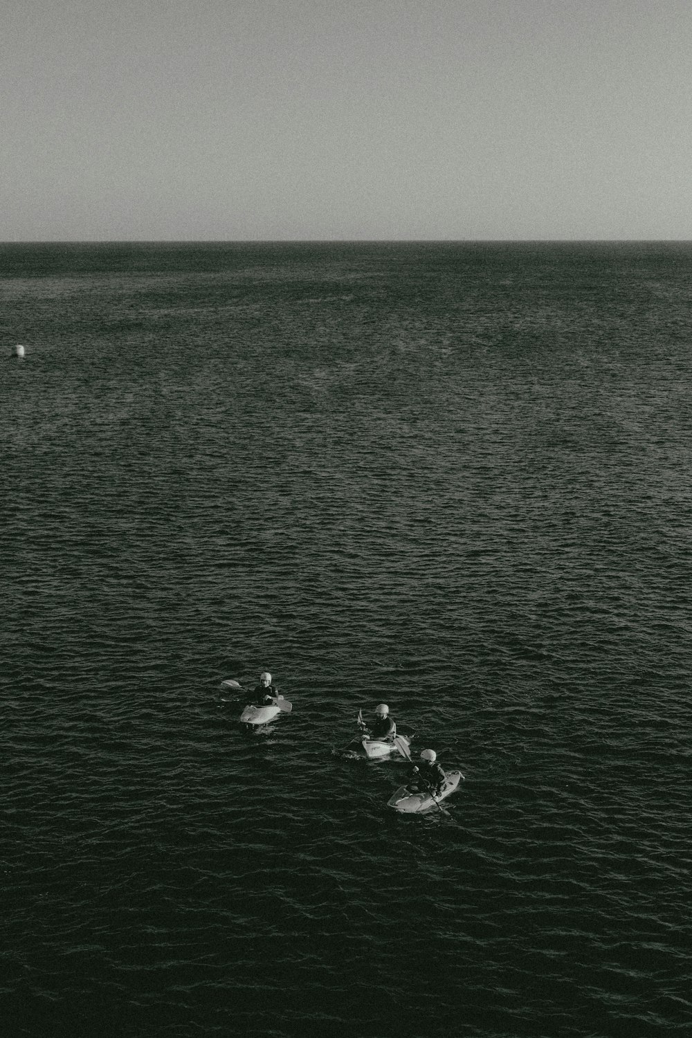 a couple of people floating on top of a body of water