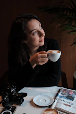 A warm, candid photo of a mom sipping coffee while managing her morning routine with kids and school bags around.