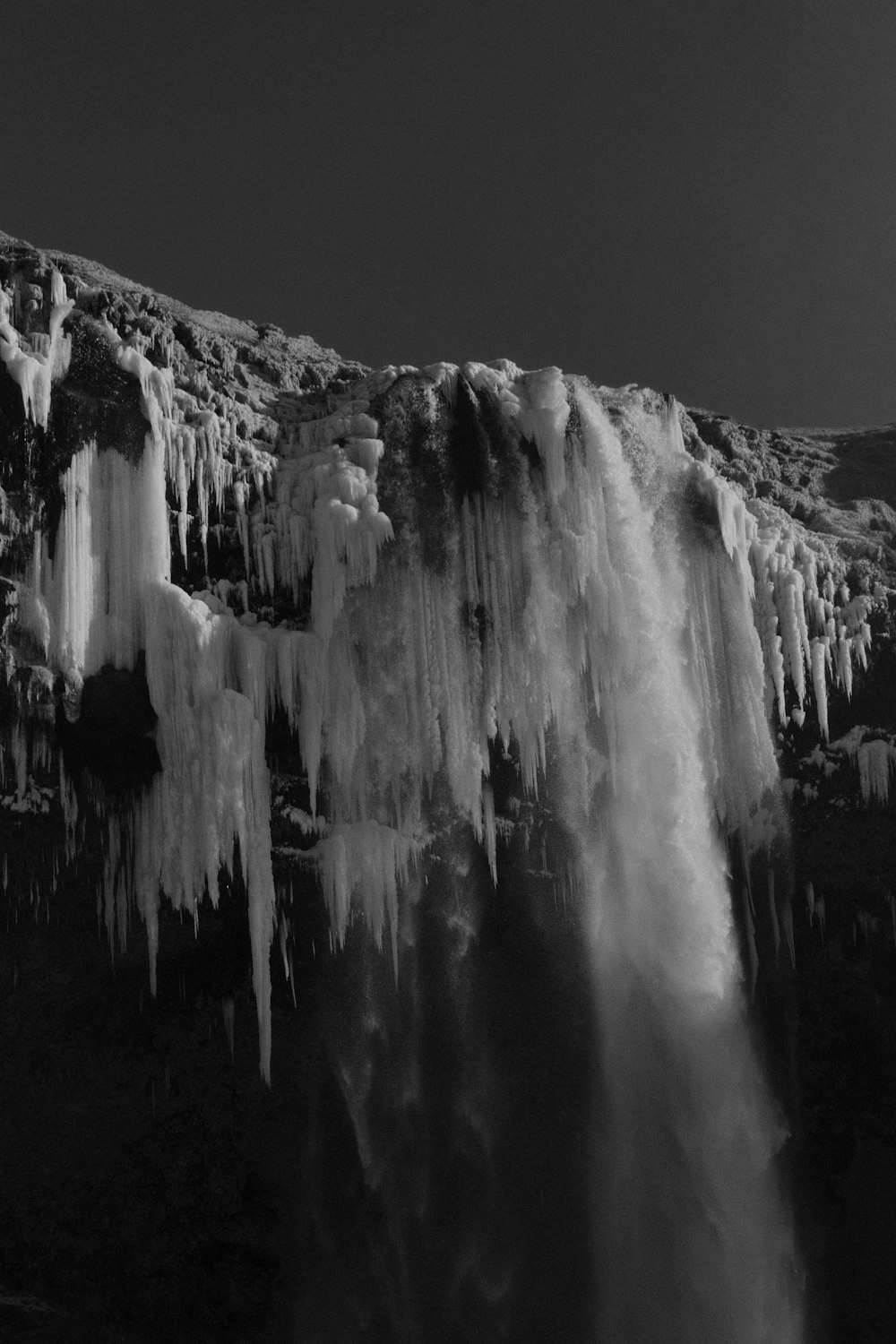 a black and white photo of a waterfall