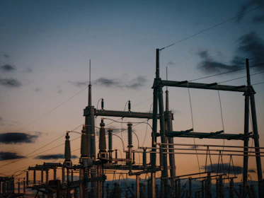 a group of power lines with a sky in the background
