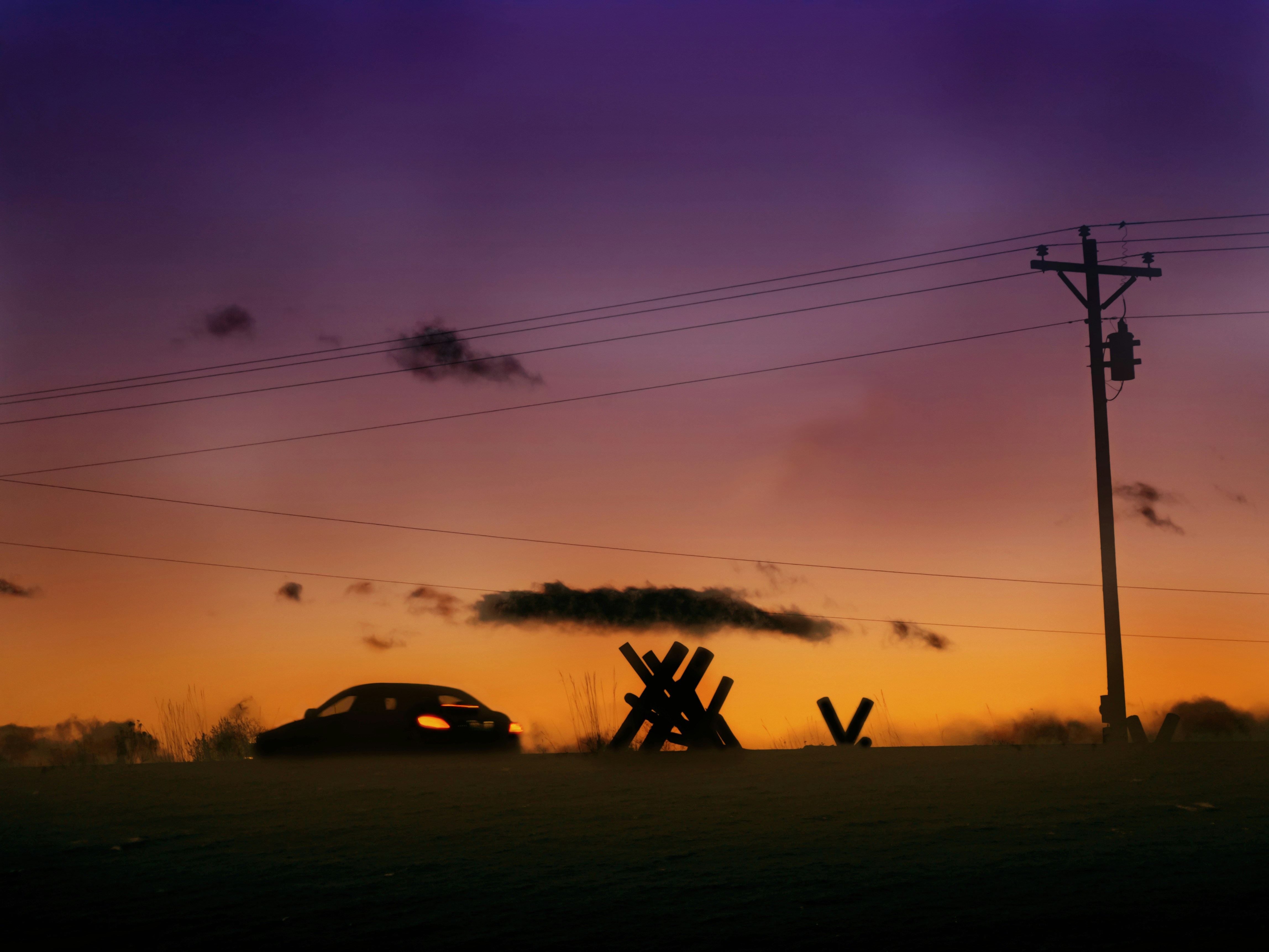 a car is parked in a field at sunset