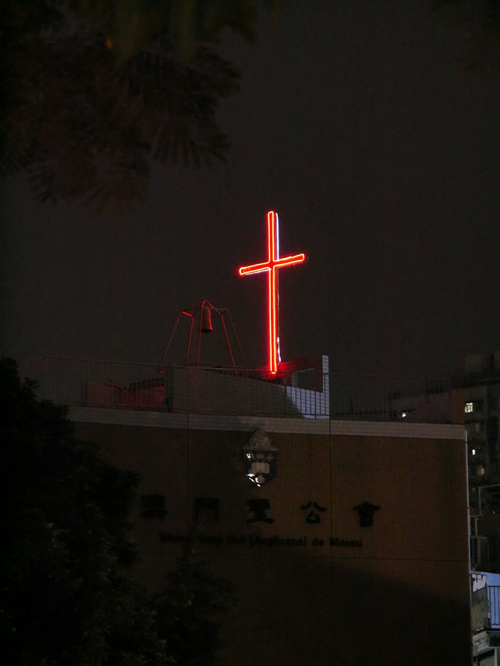 a large red cross on top of a building
