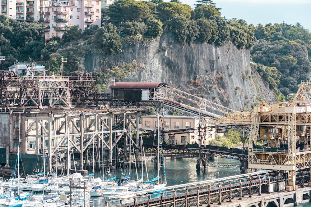 a harbor filled with lots of boats next to a mountain