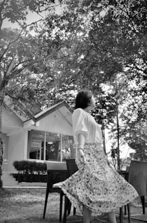 A serene outdoor scene featuring a woman in a flowing skirt.