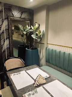 Modern dining area featuring bespoke wallpaper and high-end finishes in a warm beige tone