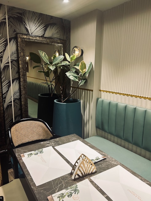 Modern dining area featuring bespoke wallpaper and high-end finishes in a warm beige tone