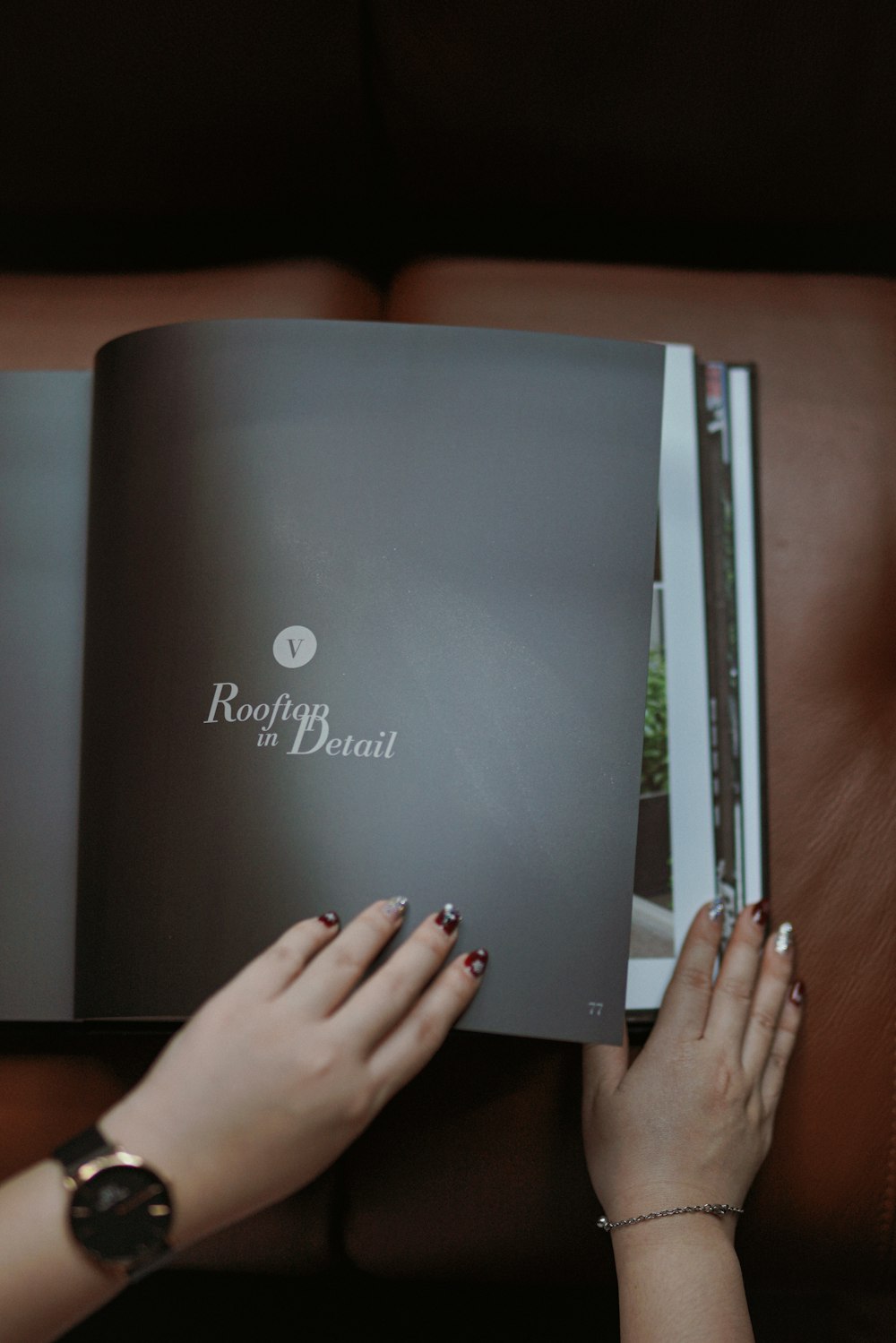 a woman is reading a book on a couch