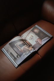 a magazine sitting on top of a brown leather couch