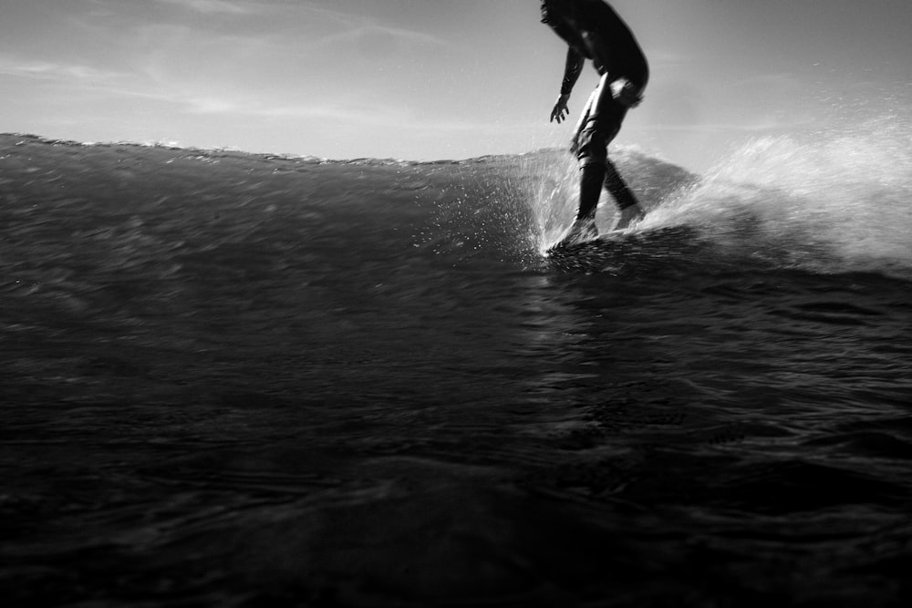 a man riding a wave on top of a surfboard