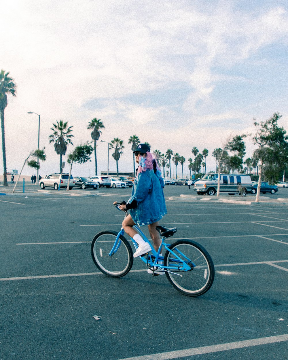 a person riding a bike in a parking lot