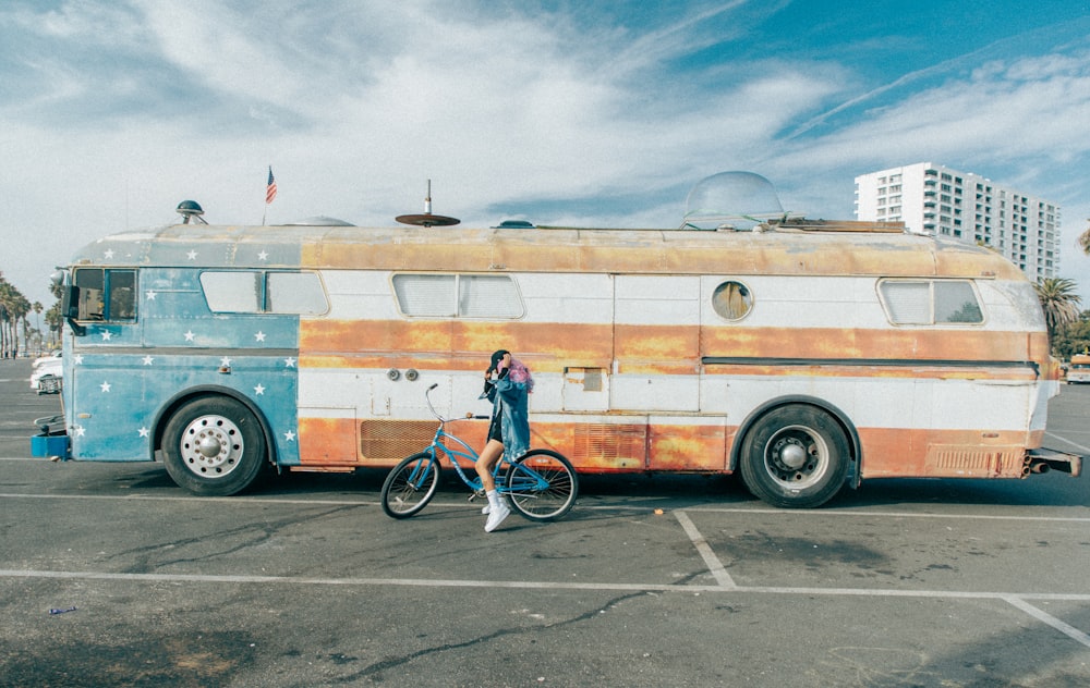 a person on a bike next to a bus