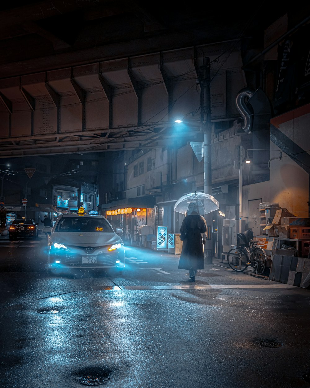 a man walking across a street holding an umbrella