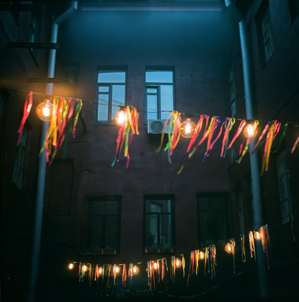 a string of lights hanging from the side of a building