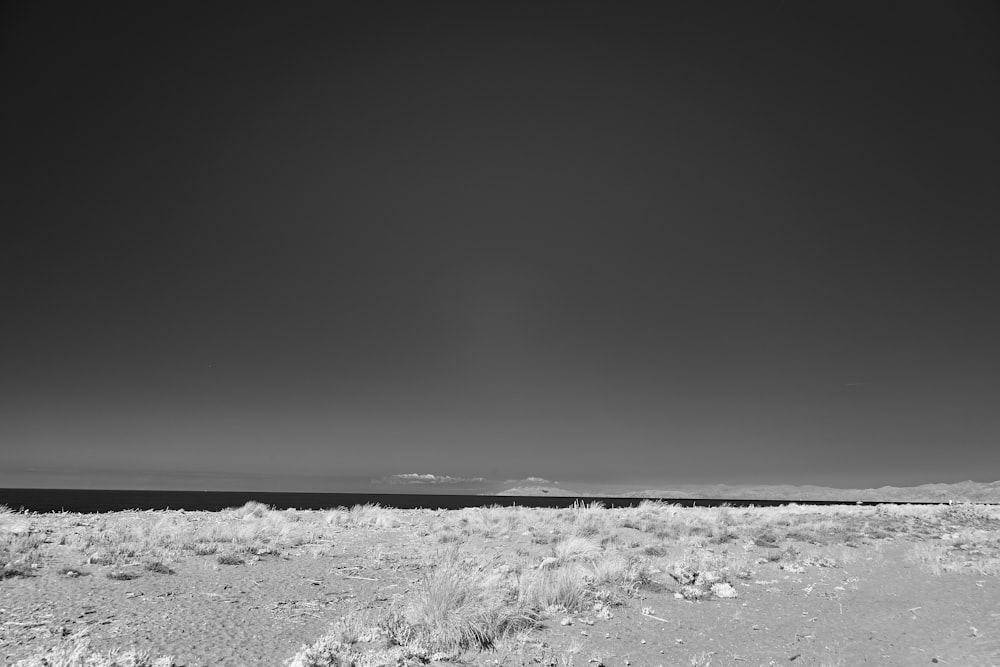 a black and white photo of an empty beach
