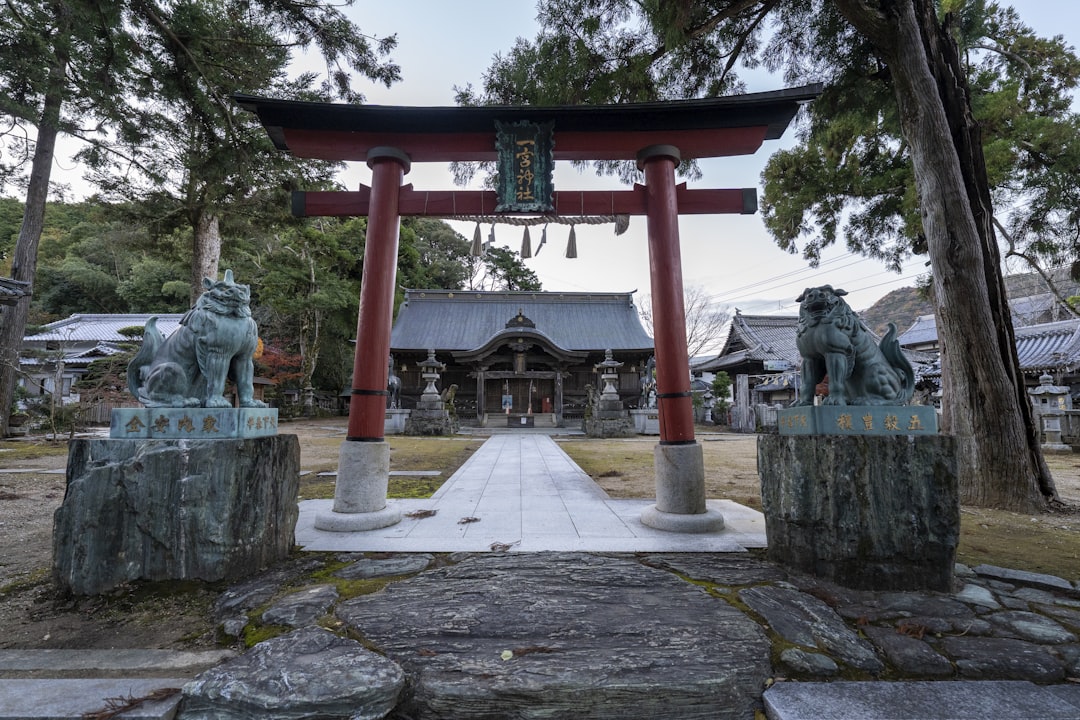 a statue of animals in front of a building, Gate at the Ichinomiya Shinto Shrine.