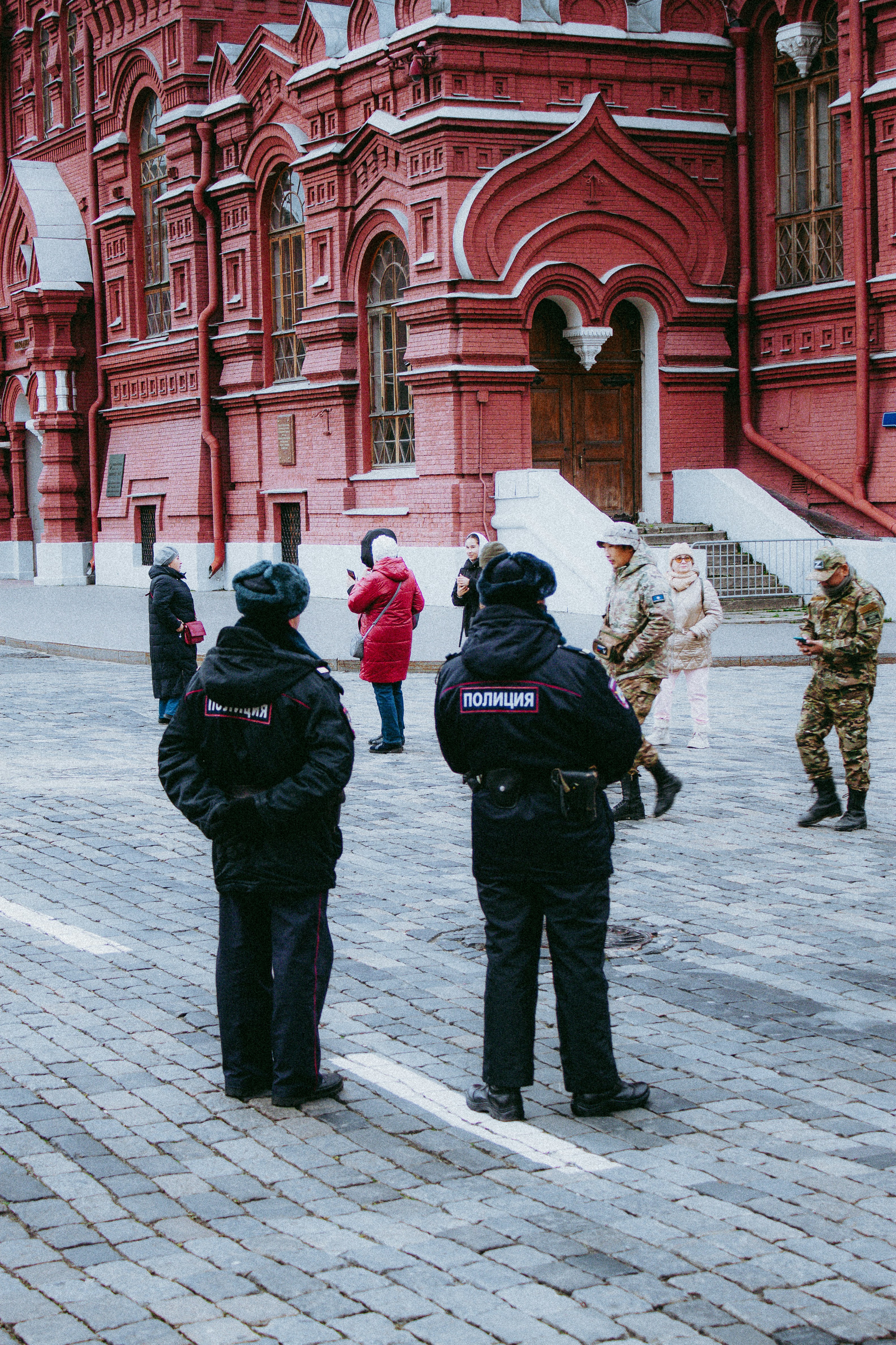 a group of police officers standing in front of a red building