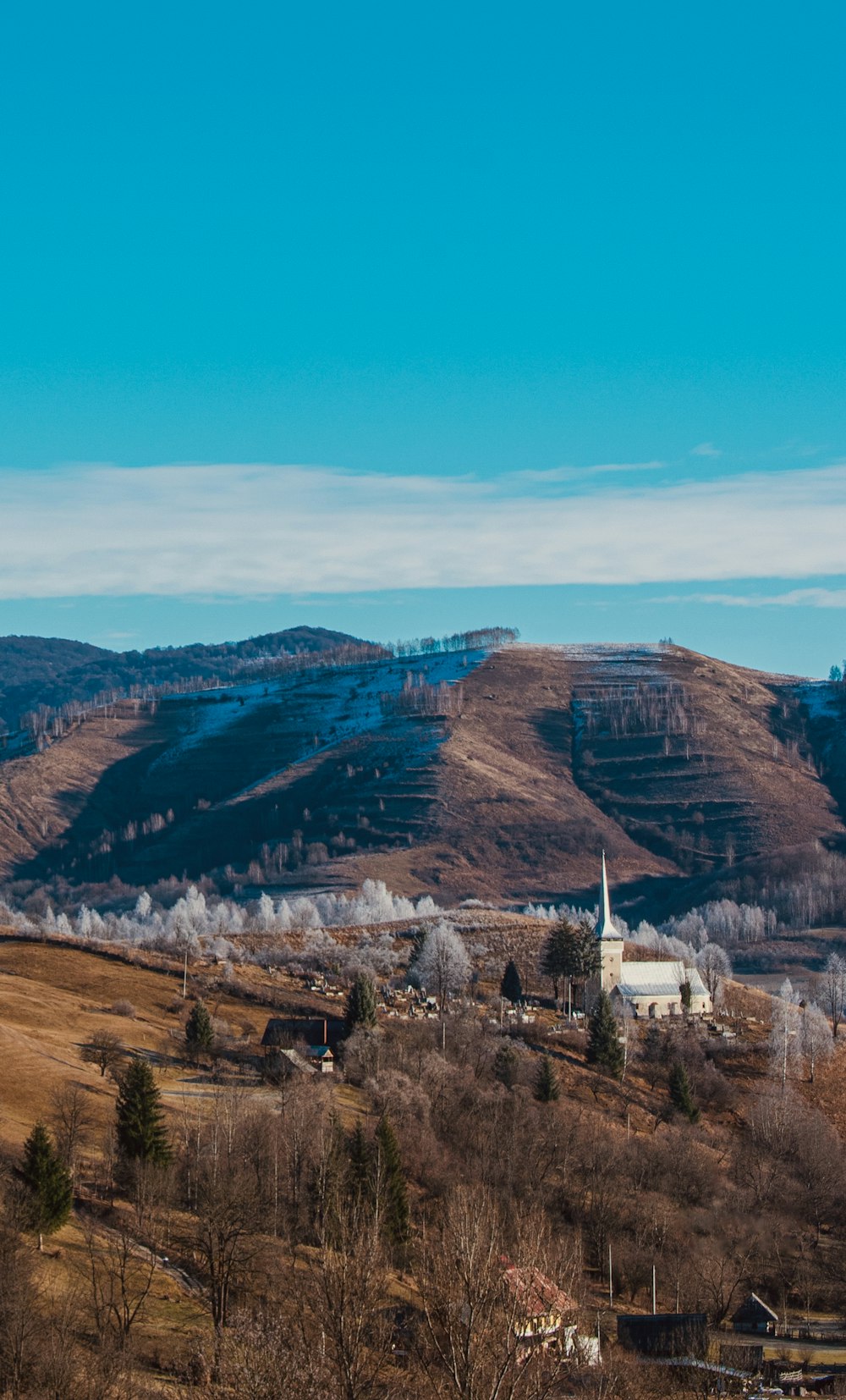 a scenic view of a small town in the mountains