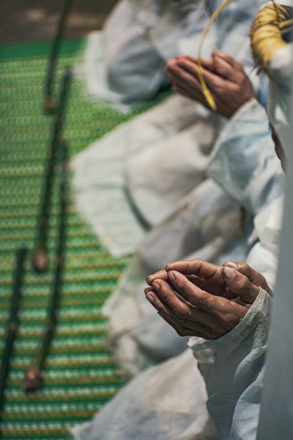 a person in white clothing holding something in their hands