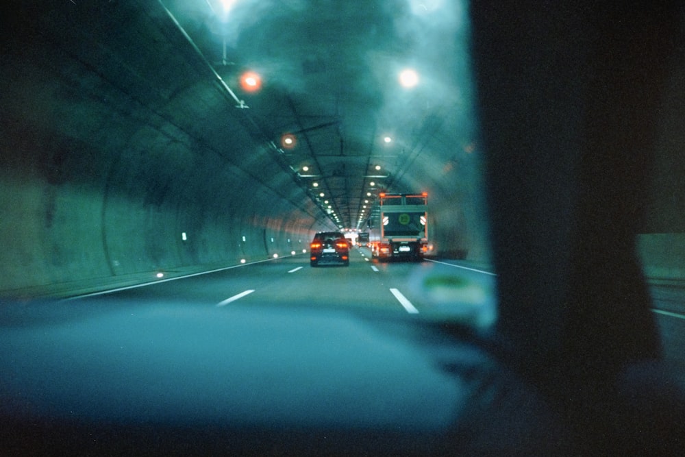 a car driving through a tunnel on a foggy day