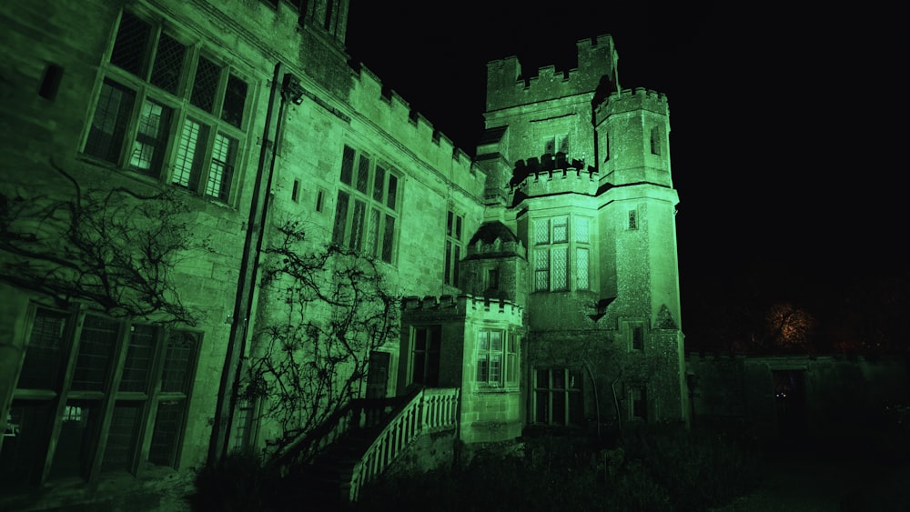 a large building with a clock tower lit up at night