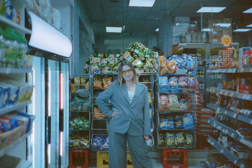 a woman standing in front of a display of food