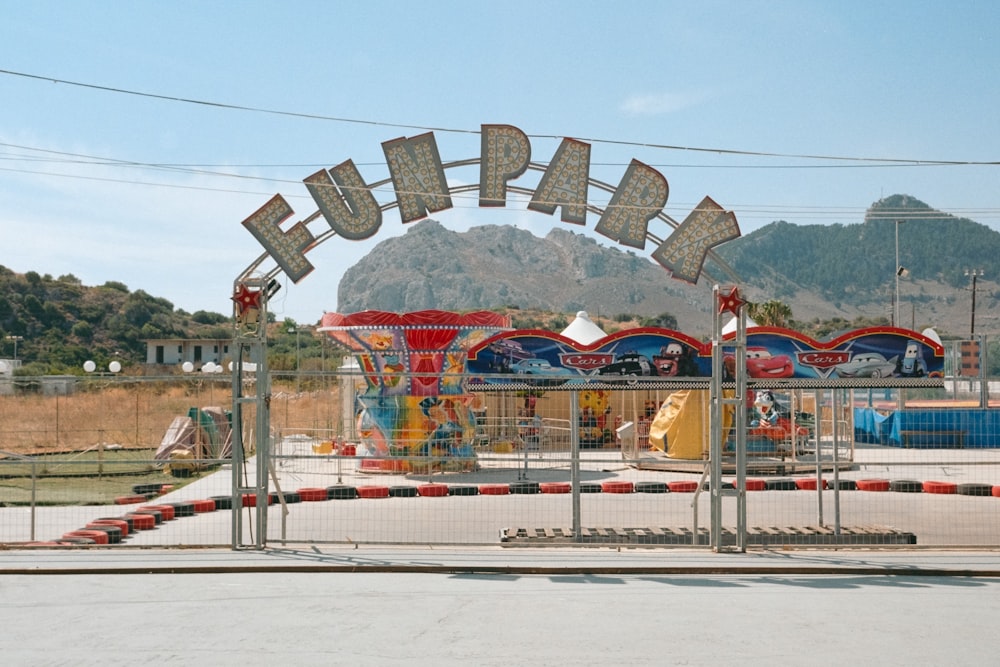 an amusement park with several rides and a sign