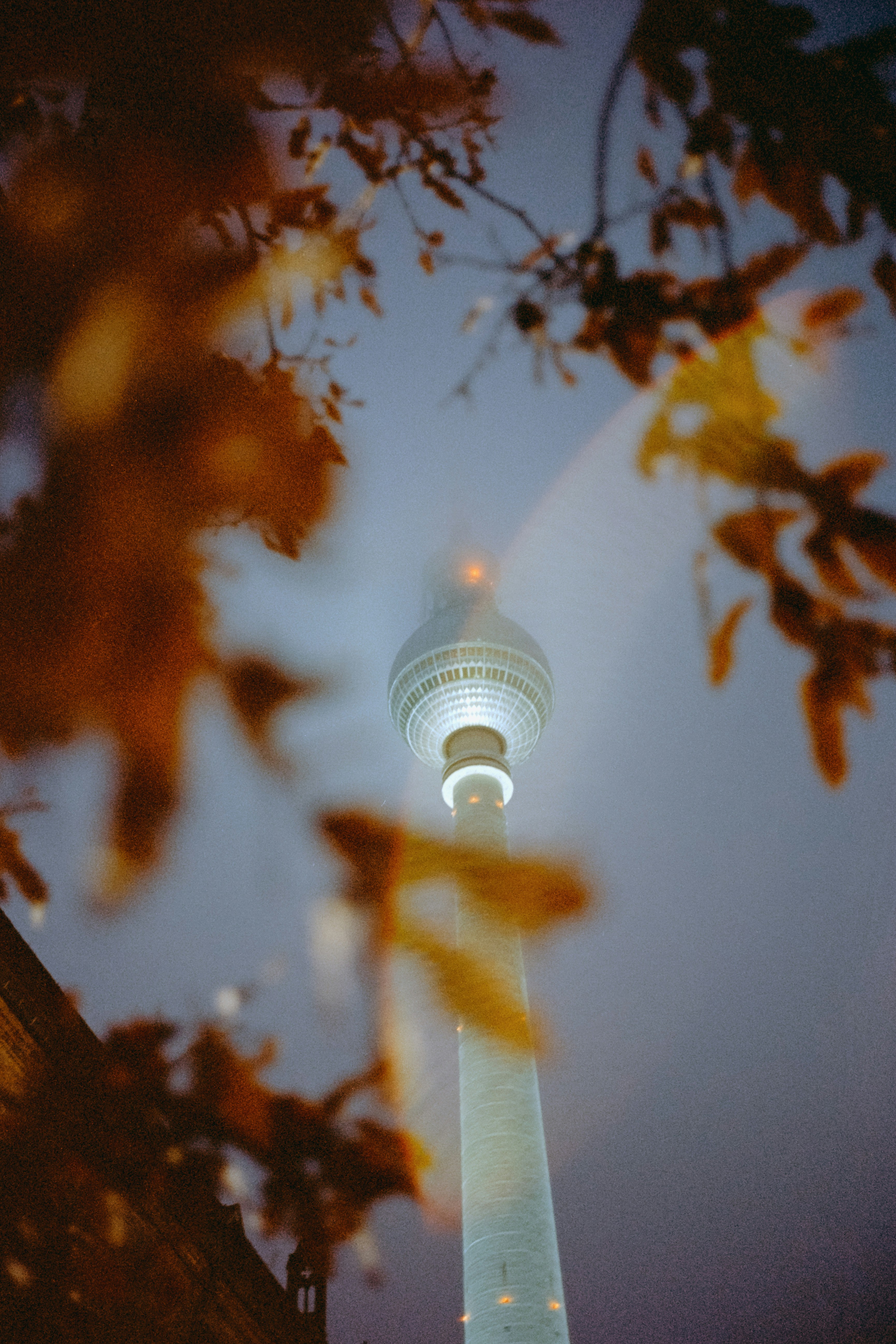 a tall light tower towering over a city at night