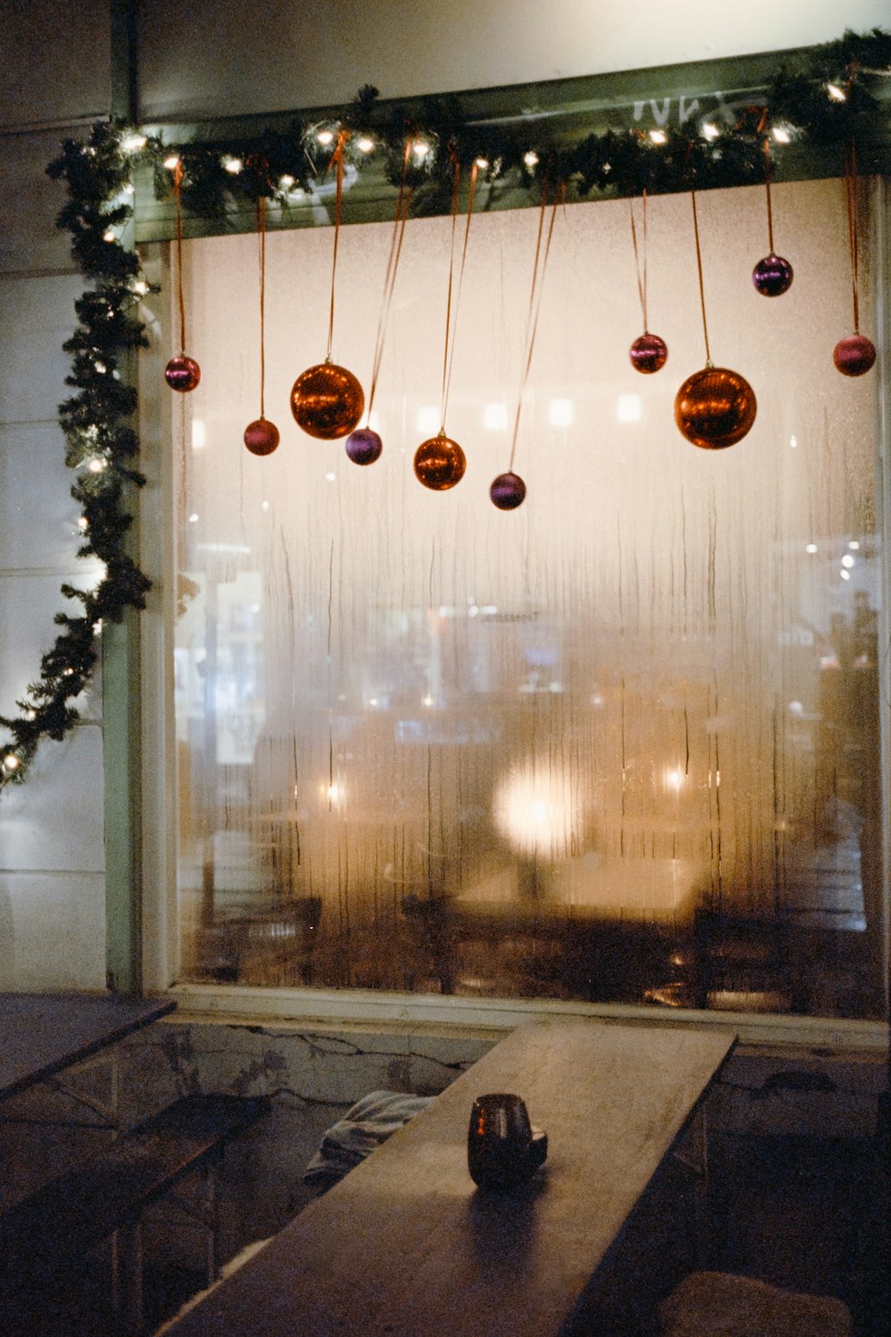 a window decorated with christmas ornaments and lights