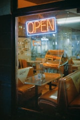 Interior of a burger restaurant decorated with 80s and 90s rock memorabilia and neon lights.