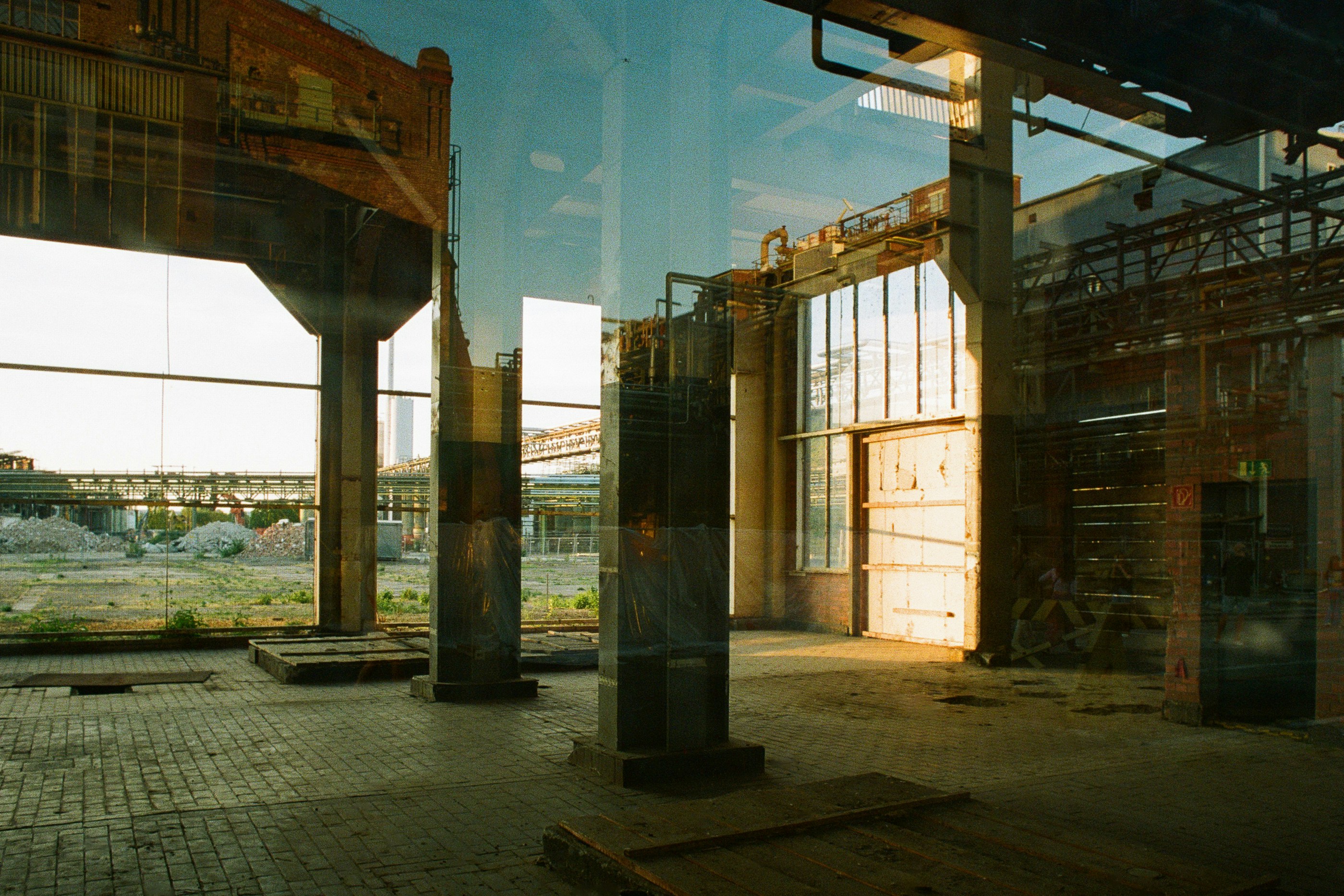 interior of a warehouse loft with concrete floors, exposed brick, and large industrial windows - artist loft for rent chicago