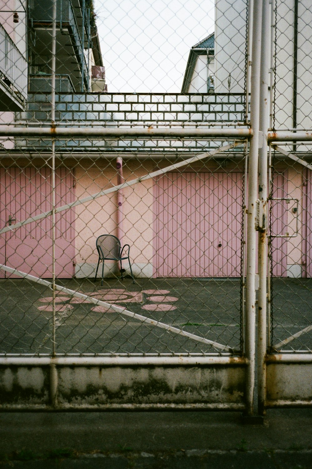 a chair sitting in front of a pink building