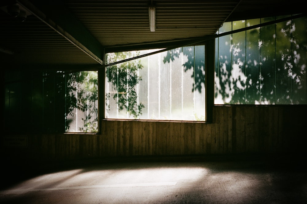 an empty room with sunlight coming through the windows