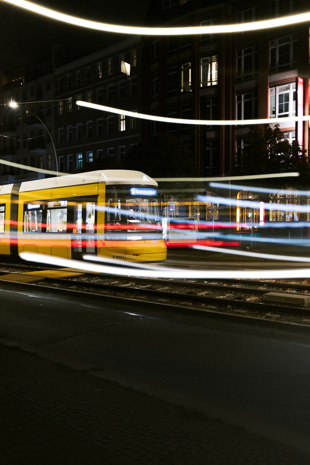 a train traveling down train tracks at night