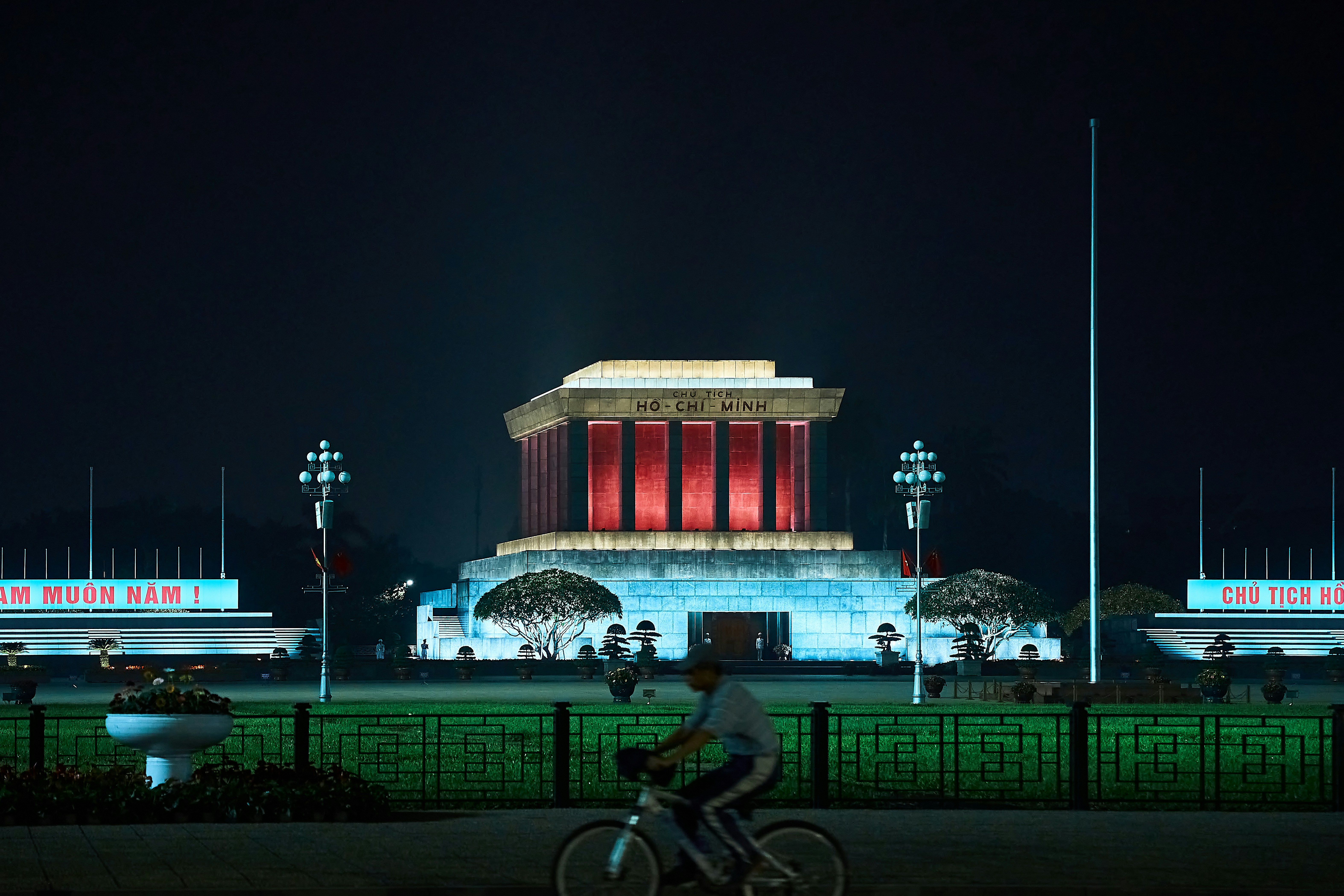 a person riding a bike in front of a building