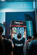 A professional team member packaging coconut charcoal with care in a modern warehouse.