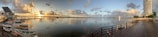 A panoramic view of a waterfront property at sunset.