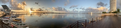 A panoramic view of a waterfront property at sunset.