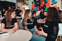 a group of people sitting around a table talking