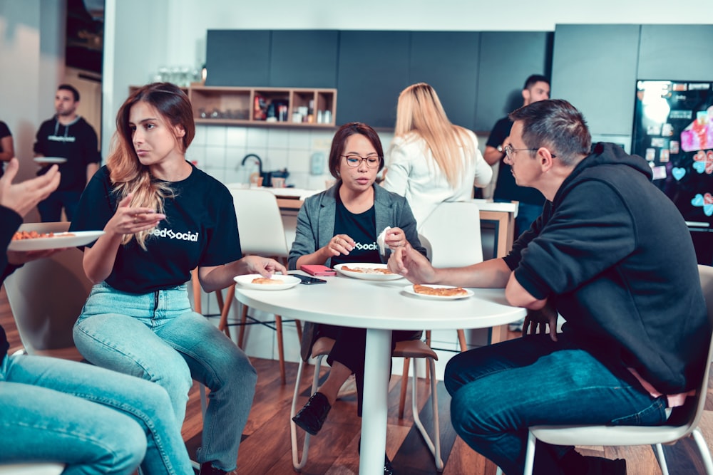 a group of people sitting around a table eating food