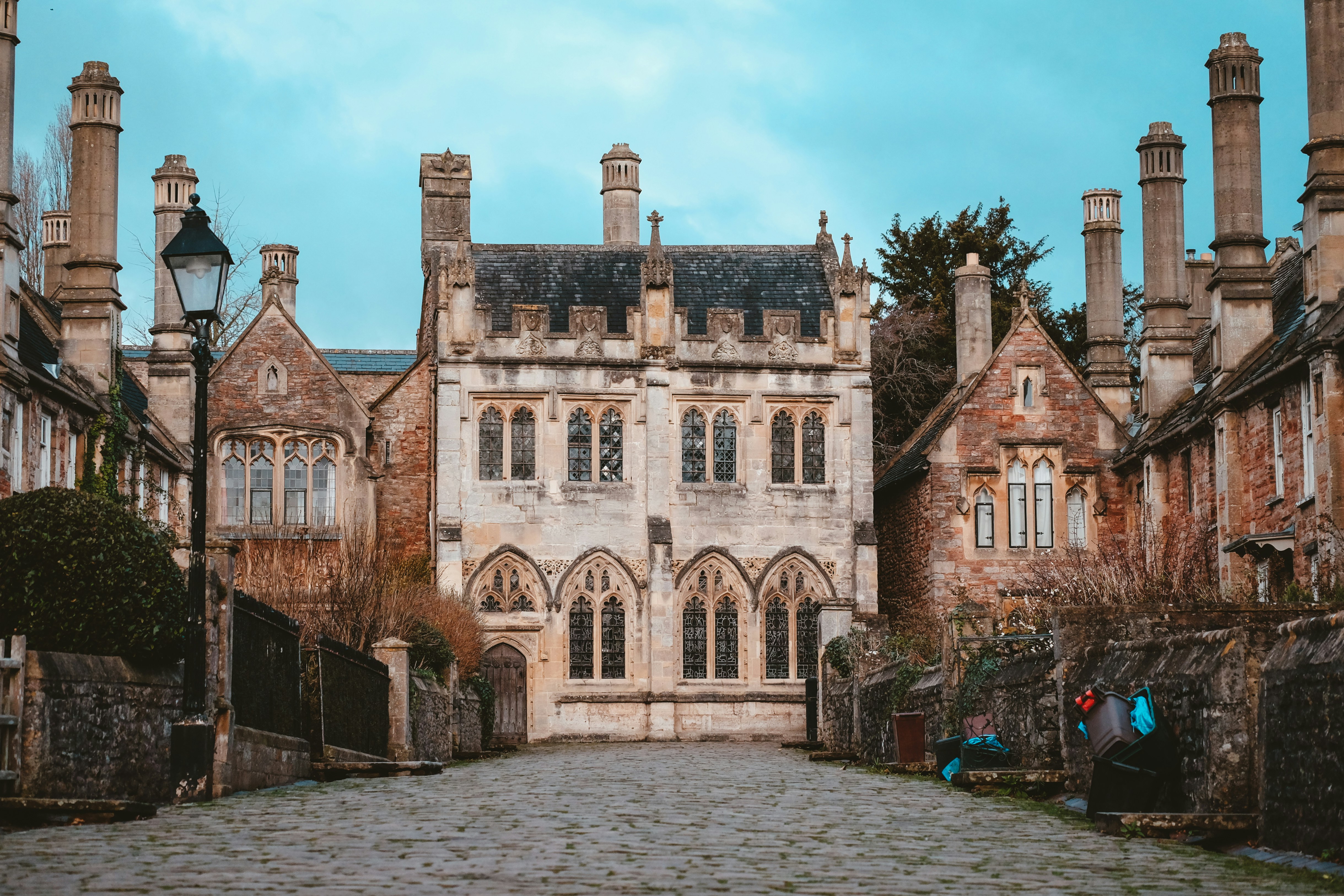 an old building with a cobblestone street in front of it, Priory Close