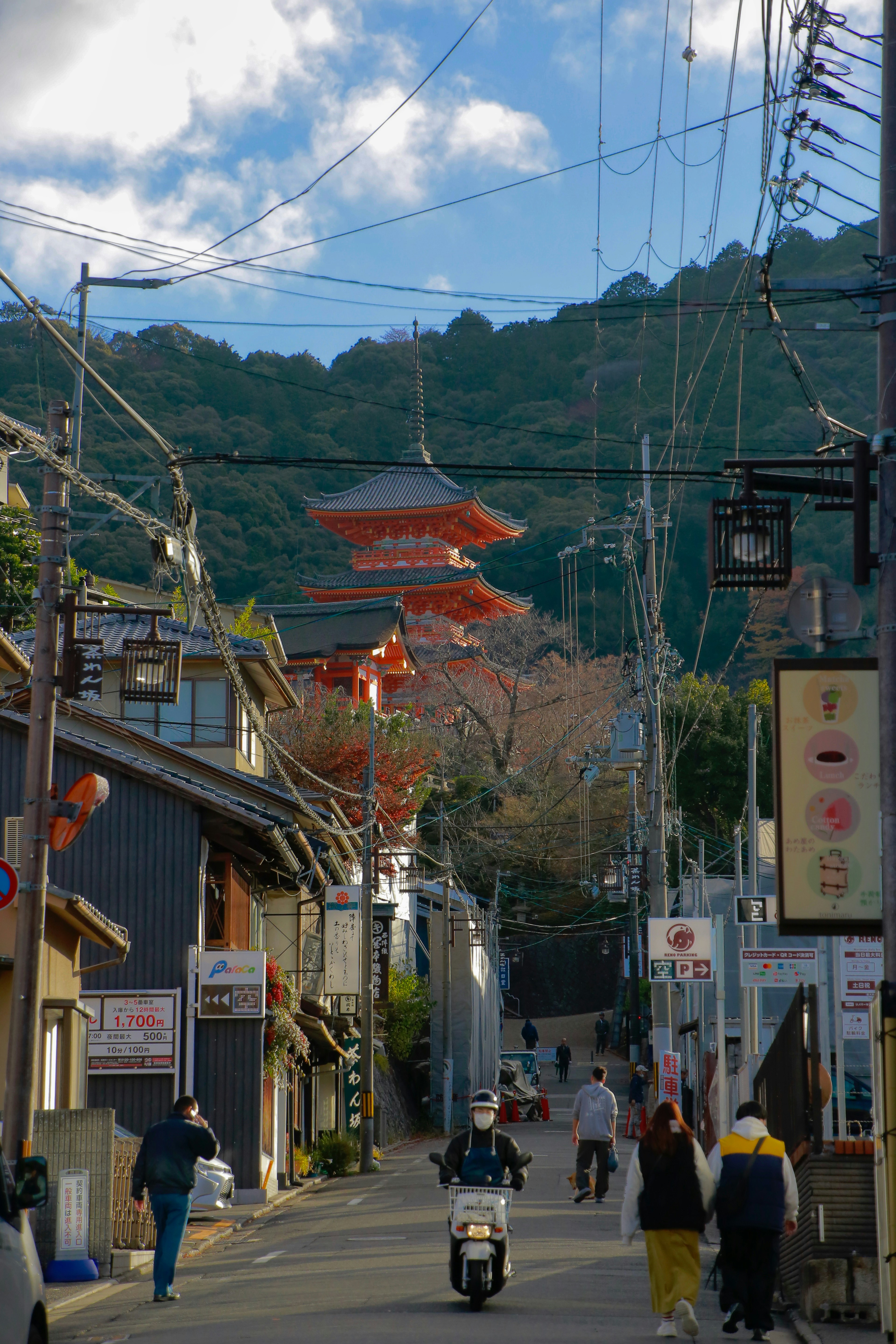 a group of people riding scooters down a street