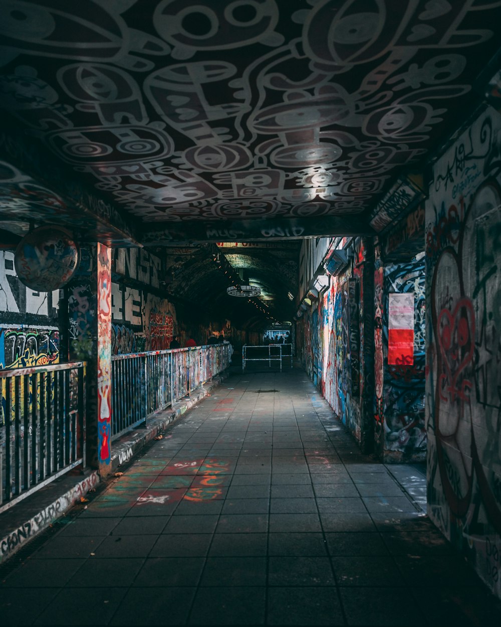 a long hallway with graffiti all over the walls