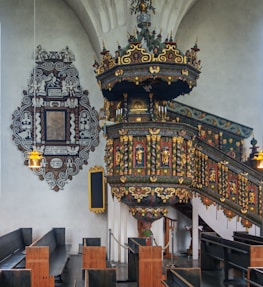 A preacher standing confidently behind an ornate pulpit, delivering a sermon in a historic church.