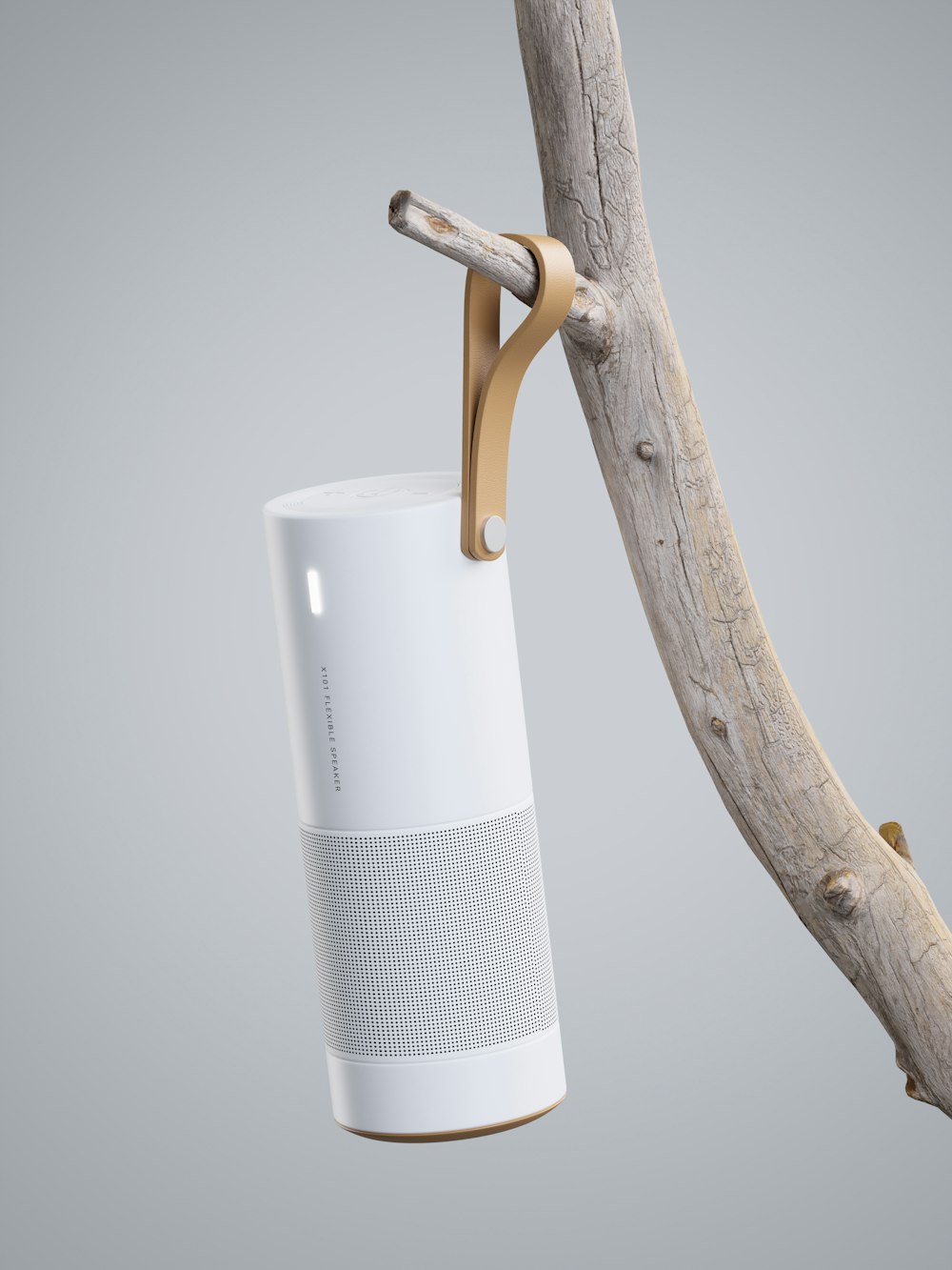 a white smart speaker hanging from a tree branch
