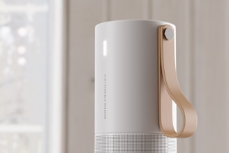 A compact wireless speaker with a minimalist design.