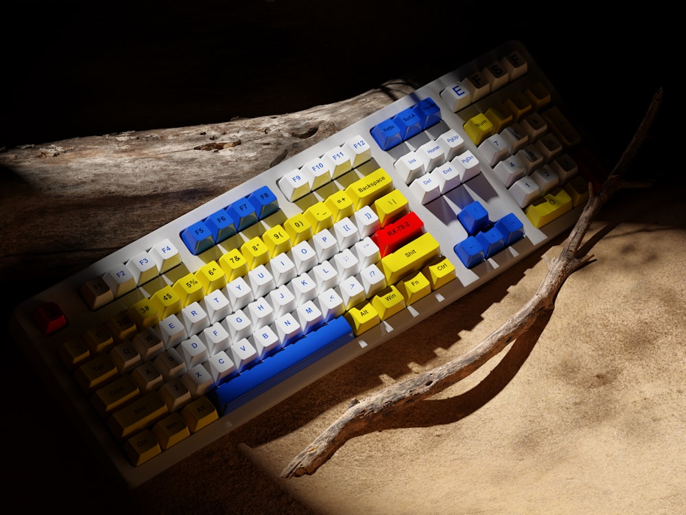 a yellow and blue keyboard sitting on top of a table