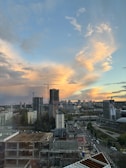 Wide shot of a city skyline with ongoing construction projects.