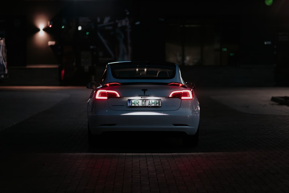 a car parked in a parking lot at night