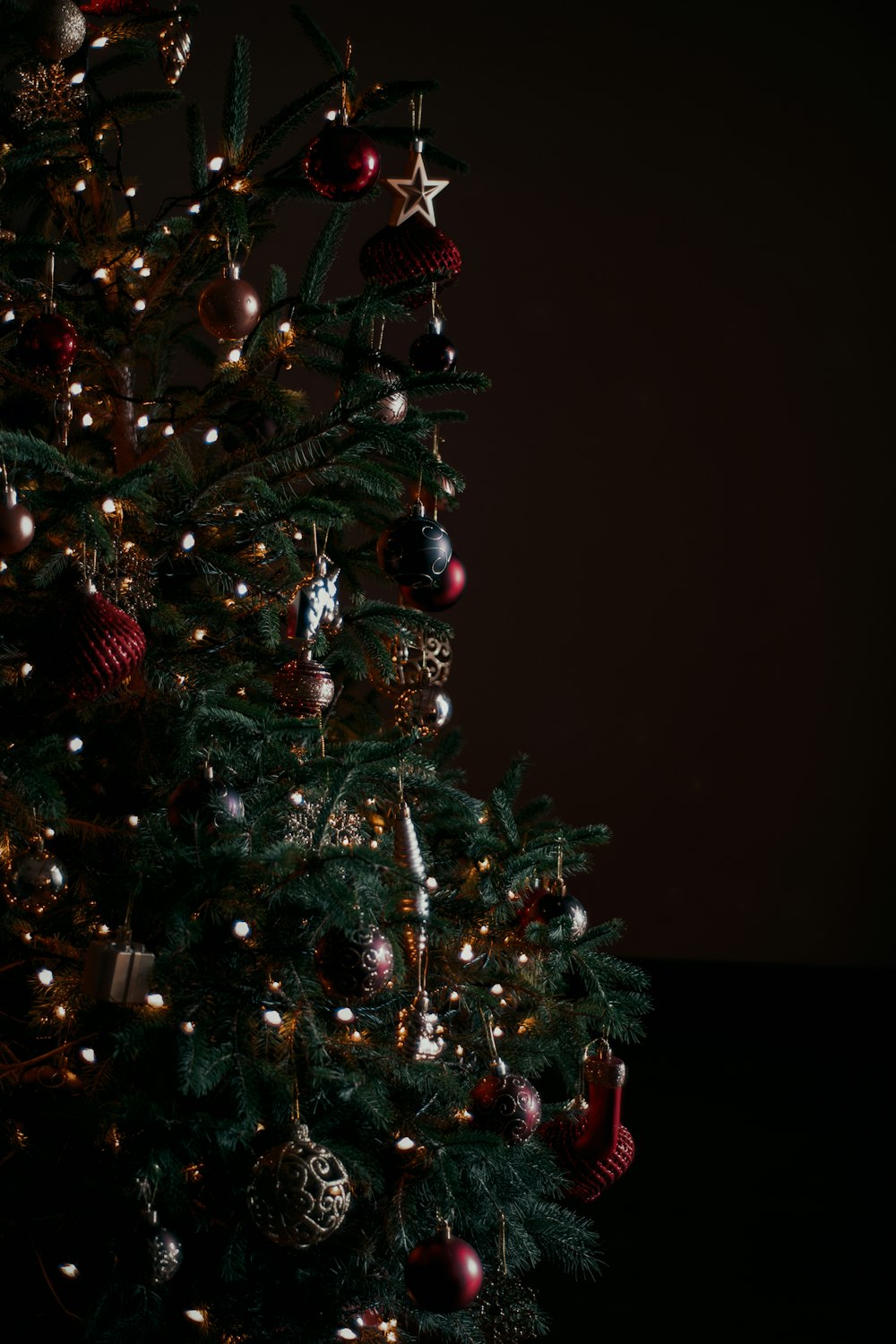 a small christmas tree with ornaments on it