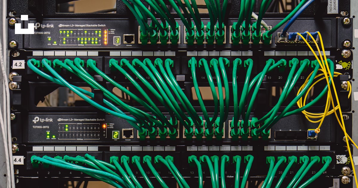 A rack with many wires and wires attached to it photo – Free Computer ...